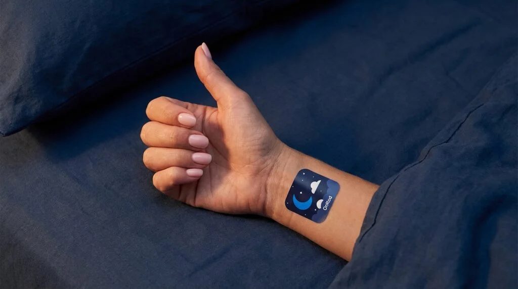 Close-up of woman applying OnNod sleep support patch to upper arm — replace with real usage photo